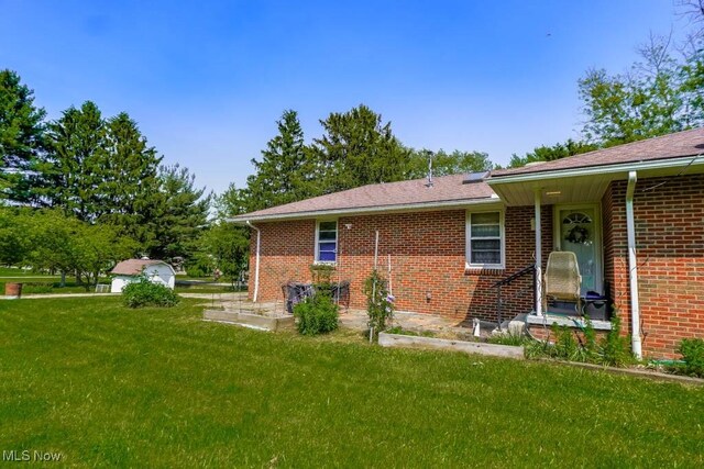 5920 Renninger Rd, New Franklin, OH 44319 - view of side of home featuring a yard and brick siding