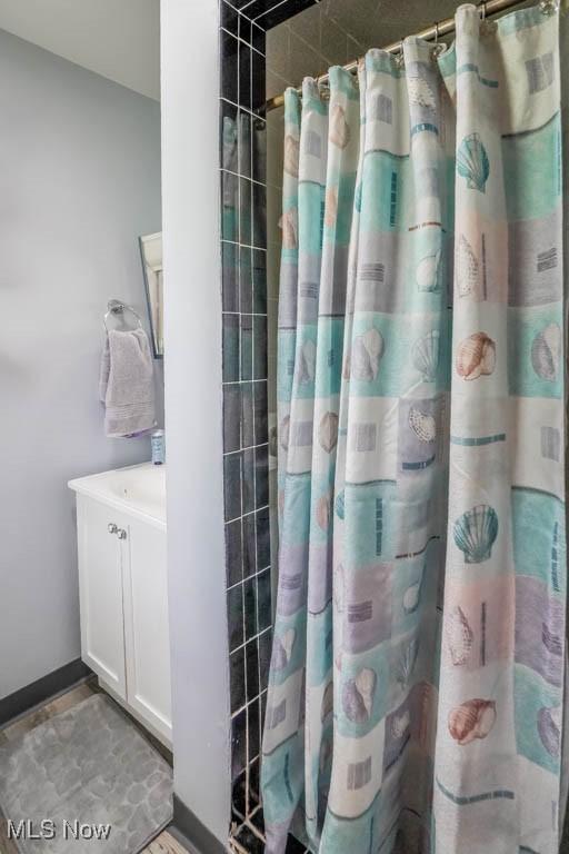 5920 Renninger Rd, New Franklin, OH 44319 - bathroom featuring vanity, a shower with shower curtain, and baseboards