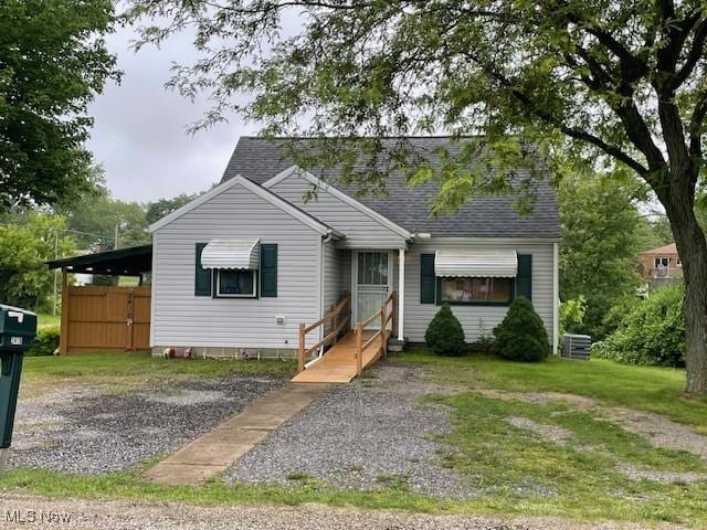 2410 Perry Dr SW, Canton, OH 44706 - view of front facade with roof with shingles and a front yard