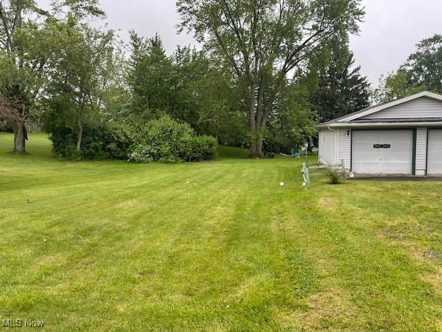 2410 Perry Dr SW, Canton, OH 44706 - view of green lawn with a garage