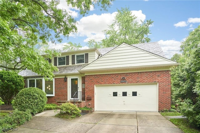 4418 Temblett Ter, South Euclid, OH 44121 - view of front facade with driveway, brick siding, and an attached garage