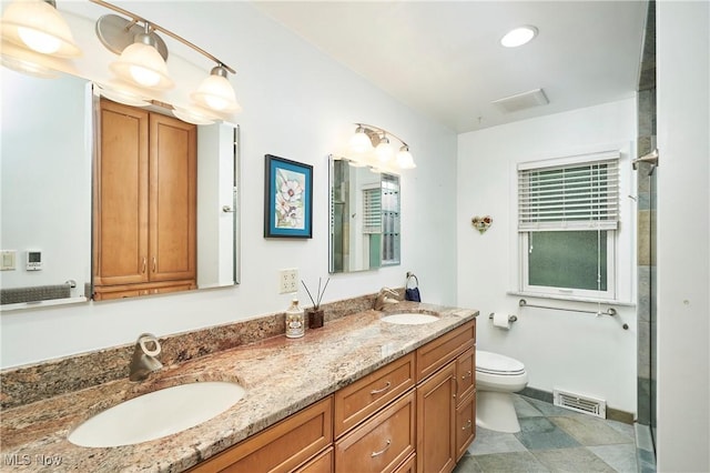 4418 Temblett Ter, South Euclid, OH 44121 - bathroom featuring double vanity, toilet, and baseboards
