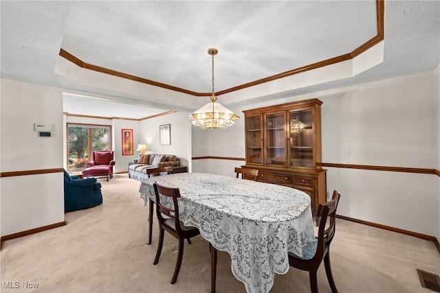 5011 Buttonbush Ln, North Royalton, OH 44133 - dining space featuring a tray ceiling, light carpet, baseboards, and crown molding