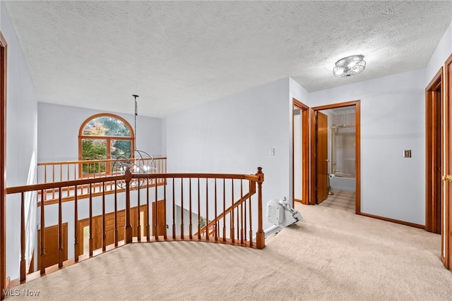 5011 Buttonbush Ln, North Royalton, OH 44133 - hall featuring light carpet, an upstairs landing, baseboards, a chandelier, and a textured ceiling