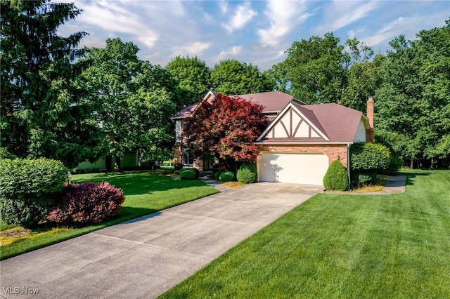 5011 Buttonbush Ln, North Royalton, OH 44133 - english style home featuring concrete driveway, a front yard, an attached garage, and a chimney