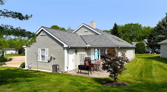 335 Devon Pond, Aurora, OH 44202 - back of property with a yard, a patio area, a chimney, and a shingled roof