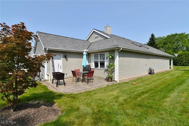 335 Devon Pond, Aurora, OH 44202 - back of property with a chimney, a patio area, a lawn, and a shingled roof