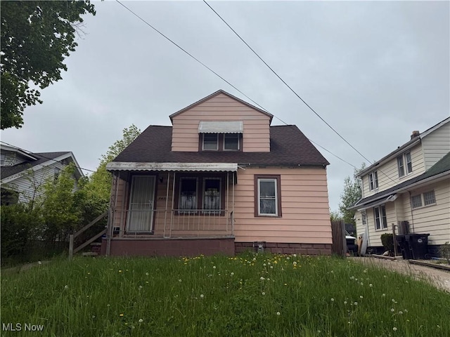 4678 E 147th St, Cleveland, OH 44128 - back of property with covered porch, a yard, and a shingled roof