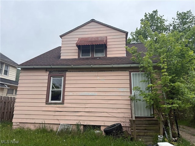 4678 E 147th St, Cleveland, OH 44128 - view of property exterior featuring entry steps and a shingled roof