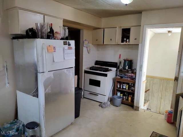 4549 Lee Rd, Cleveland, OH 44128 - kitchen featuring white appliances, white cabinets, and tasteful backsplash