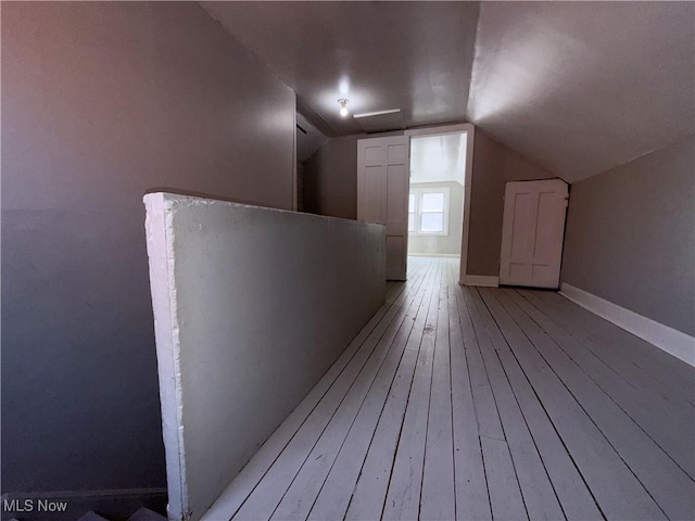 3877 E 153rd St, Cleveland, OH 44128 - additional living space featuring light wood finished floors, vaulted ceiling, and baseboards