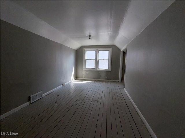 3877 E 153rd St, Cleveland, OH 44128 - bonus room with wood-type flooring, vaulted ceiling, and baseboards