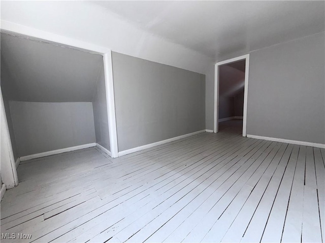 3877 E 153rd St, Cleveland, OH 44128 - additional living space featuring hardwood / wood-style flooring, lofted ceiling, and baseboards