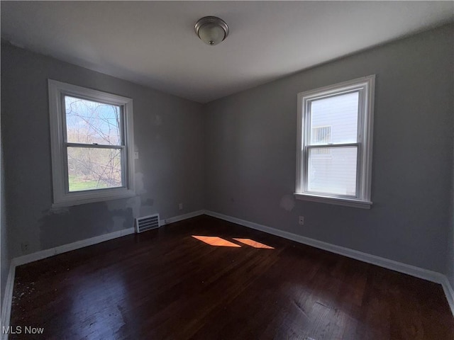 3877 E 153rd St, Cleveland, OH 44128 - spare room featuring dark wood-style floors and baseboards