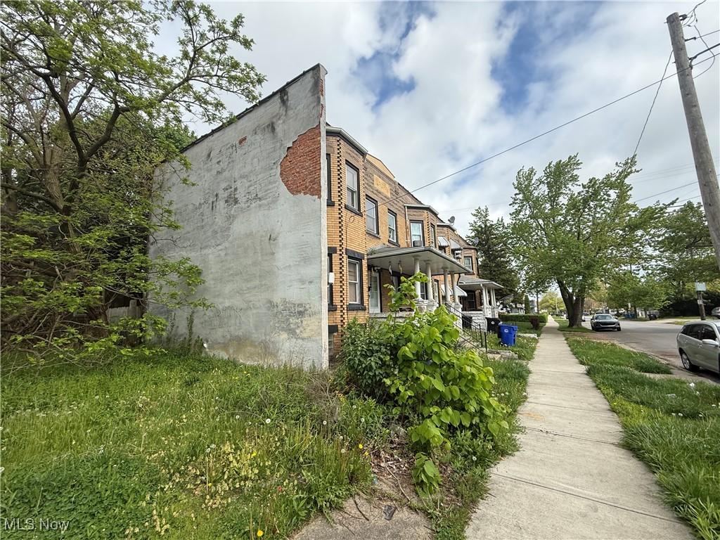 2110 W 98th St, Cleveland, OH 44102 - view of side of property with a porch and brick siding