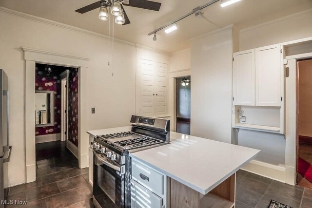 490 N Main St, Magnolia, OH 44643 - kitchen with appliances with stainless steel finishes, a ceiling fan, light countertops, white cabinetry, and ornamental molding
