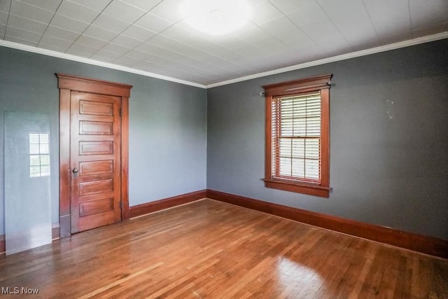 490 N Main St, Magnolia, OH 44643 - spare room with crown molding, healthy amount of natural light, wood finished floors, and baseboards