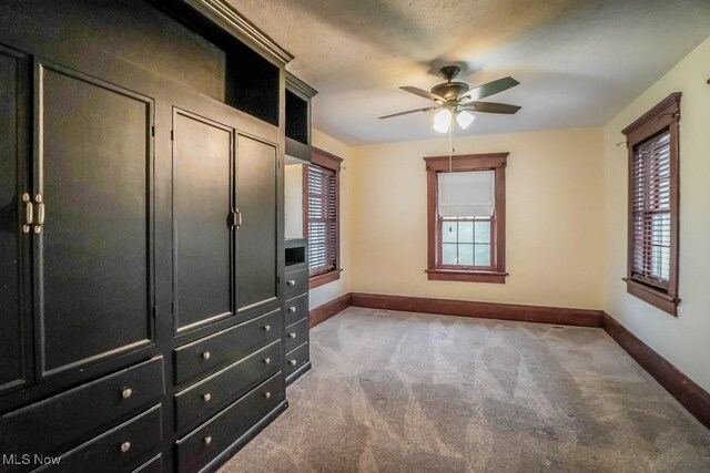 490 N Main St, Magnolia, OH 44643 - unfurnished bedroom with baseboards, carpet flooring, and ceiling fan