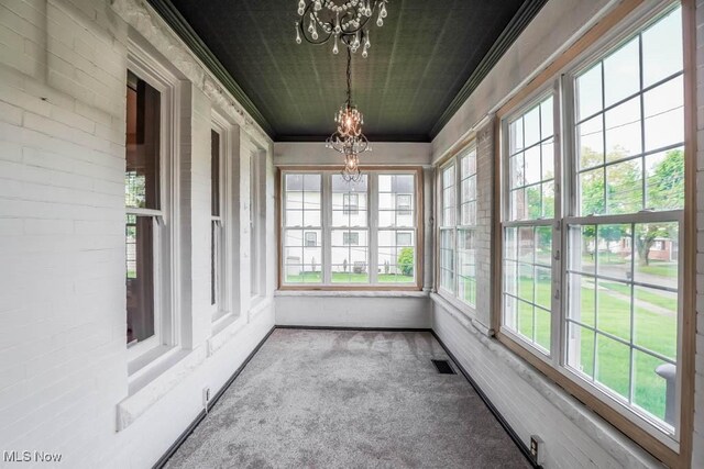 490 N Main St, Magnolia, OH 44643 - unfurnished sunroom featuring a chandelier, carpet flooring, healthy amount of natural light, and ornamental molding