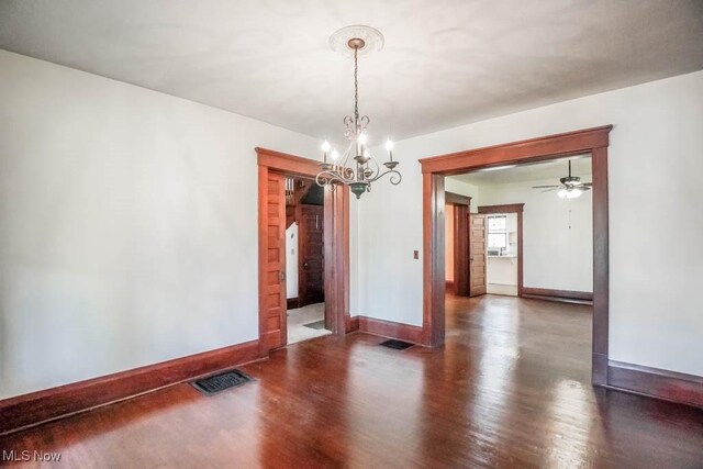 490 N Main St, Magnolia, OH 44643 - empty room featuring a chandelier, wood finished floors, baseboards, and ceiling fan