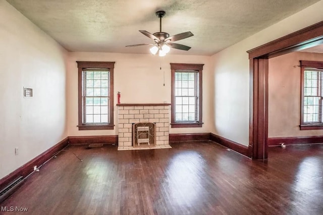 490 N Main St, Magnolia, OH 44643 - unfurnished living room featuring wood finished floors, baseboards, plenty of natural light, a ceiling fan, and a textured ceiling