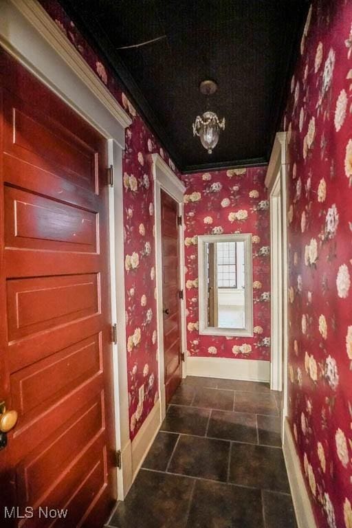 490 N Main St, Magnolia, OH 44643 - hallway with baseboards, wallpapered walls, dark tile patterned floors, and crown molding