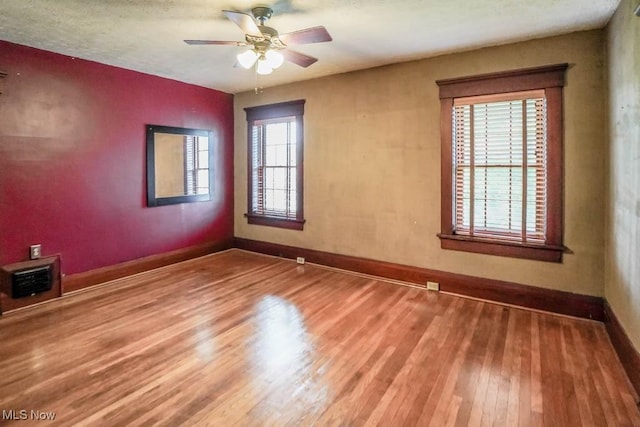 490 N Main St, Magnolia, OH 44643 - unfurnished room featuring baseboards, wood finished floors, and ceiling fan
