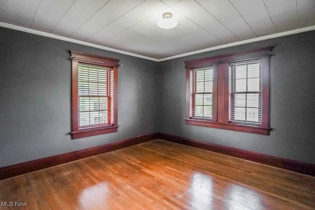 490 N Main St, Magnolia, OH 44643 - unfurnished room featuring ornamental molding, healthy amount of natural light, wood finished floors, and baseboards