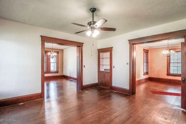 490 N Main St, Magnolia, OH 44643 - empty room featuring a chandelier, healthy amount of natural light, and wood finished floors