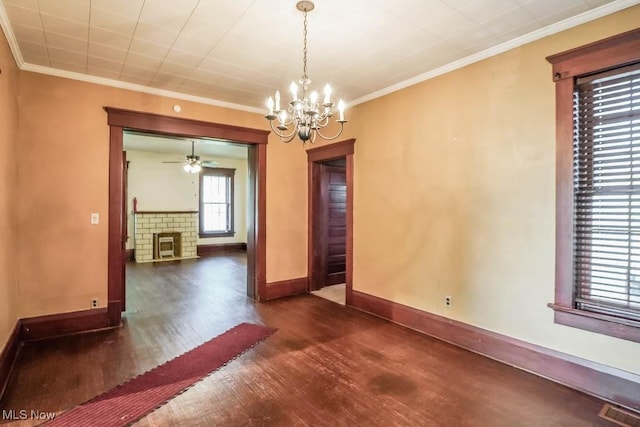 490 N Main St, Magnolia, OH 44643 - unfurnished room featuring wood finished floors, baseboards, a chandelier, a brick fireplace, and ornamental molding