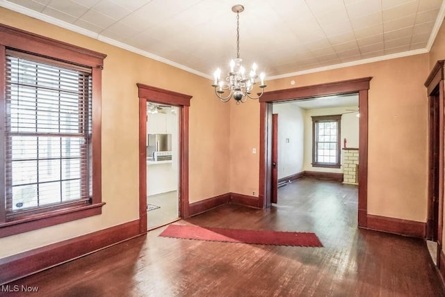 490 N Main St, Magnolia, OH 44643 - unfurnished dining area with a chandelier, dark wood finished floors, baseboards, and ornamental molding
