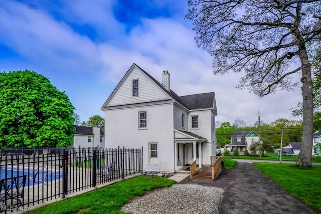 490 N Main St, Magnolia, OH 44643 - view of property exterior with a chimney and stucco siding