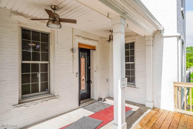490 N Main St, Magnolia, OH 44643 - view of exterior entry featuring a ceiling fan, brick siding, and a porch