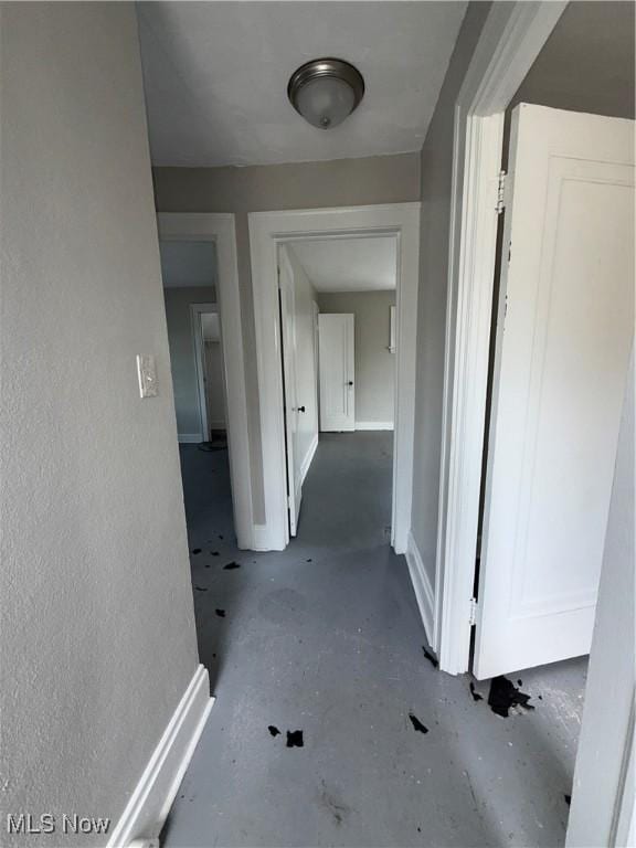 15002 Kingsford Ave, Cleveland, OH 44128 - corridor featuring concrete flooring and baseboards