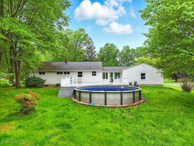 1795 Far View Rd, Green, OH 44312 - back of property with a wooden deck, an outdoor pool, and a lawn