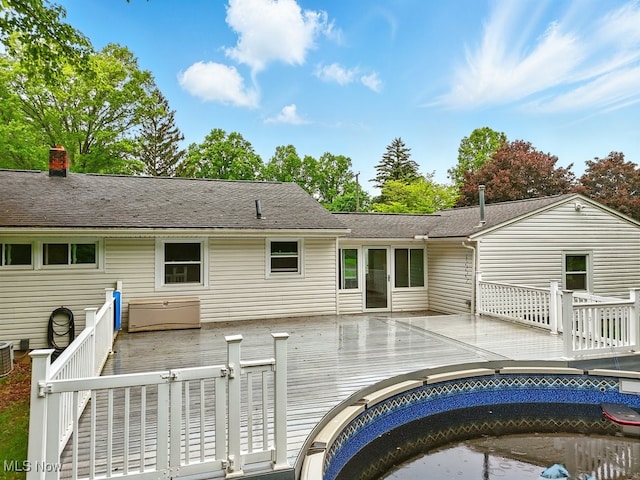 1795 Far View Rd, Green, OH 44312 - back of house with a wooden deck, a chimney, cooling unit, and roof with shingles