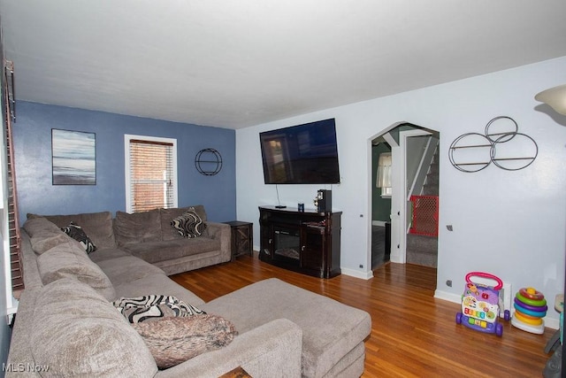 208 Como St, Struthers, OH 44471 - living area with wood finished floors, stairs, and baseboards