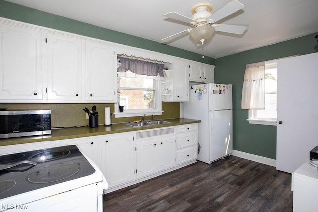 208 Como St, Struthers, OH 44471 - kitchen featuring white appliances, a sink, dark wood finished floors, white cabinets, and a ceiling fan