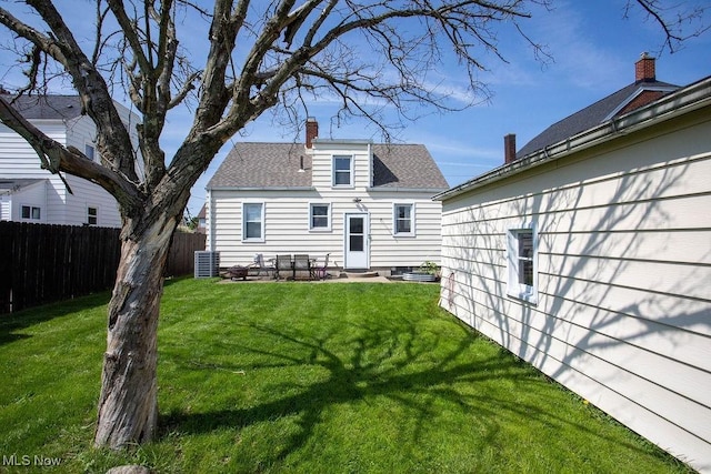 208 Como St, Struthers, OH 44471 - back of house with a chimney, entry steps, a shingled roof, and a patio