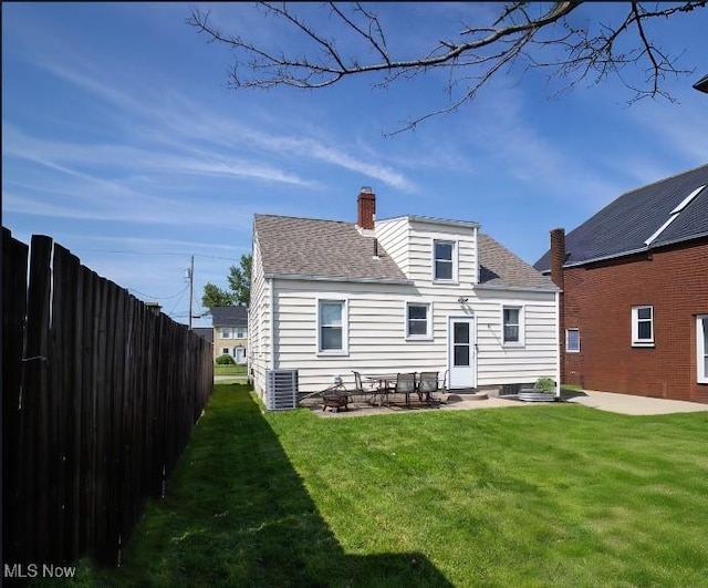 208 Como St, Struthers, OH 44471 - rear view of property with a patio, roof with shingles, a chimney, and central AC