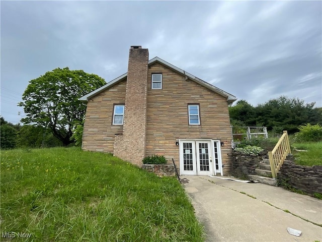 17184 State Route 45, Wellsville, OH 43968 - rear view of property with a chimney, french doors, and stone siding