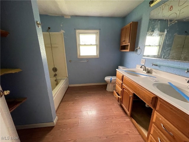 17184 State Route 45, Wellsville, OH 43968 - full bath with wood finished floors, toilet, double vanity, baseboards, and shower / bathtub combination