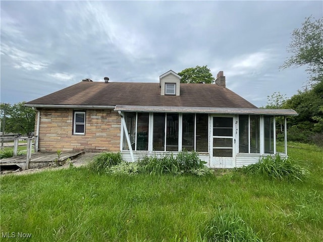 17184 State Route 45, Wellsville, OH 43968 - rear view of house with a sunroom, a chimney, stone siding, and a deck