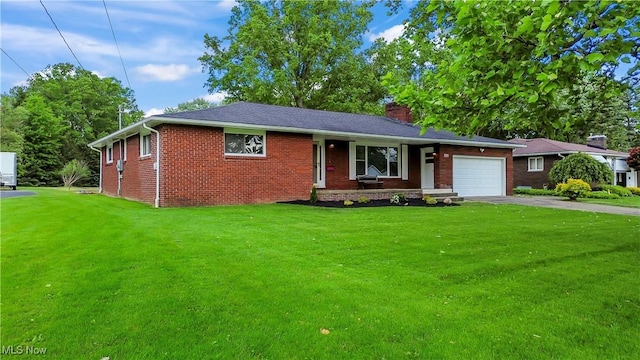 525 Cynthia Dr, Campbell, OH 44405 - view of front of home with asphalt driveway, an attached garage, a front lawn, a chimney, and brick siding