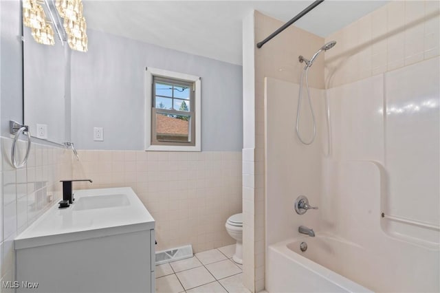 525 Cynthia Dr, Campbell, OH 44405 - bathroom featuring tile walls, vanity, shower / washtub combination, tile patterned flooring, and wainscoting