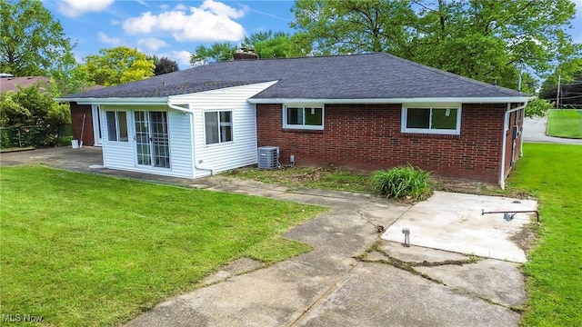 525 Cynthia Dr, Campbell, OH 44405 - back of house with a patio, a lawn, and brick siding