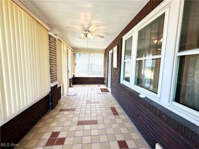 808 Gilbert Ave, Follansbee, WV 26037 - unfurnished sunroom with brick wall, ceiling fan, plenty of natural light, and tile patterned flooring