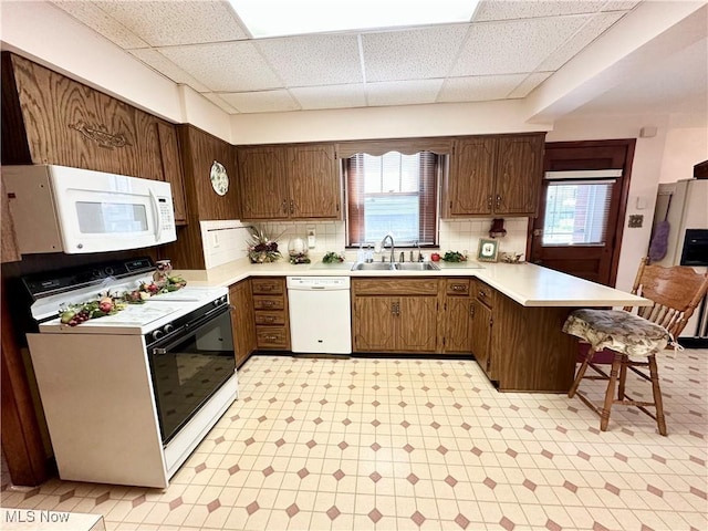 808 Gilbert Ave, Follansbee, WV 26037 - kitchen with white appliances, a peninsula, a sink, light flooring, and a drop ceiling