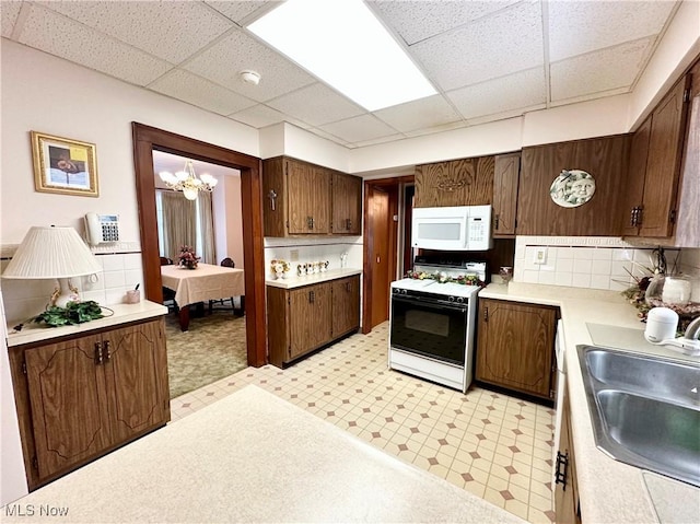 808 Gilbert Ave, Follansbee, WV 26037 - kitchen featuring white microwave, range with gas stovetop, a sink, light flooring, and a paneled ceiling