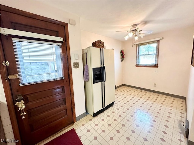 808 Gilbert Ave, Follansbee, WV 26037 - kitchen featuring white refrigerator with ice dispenser, a ceiling fan, baseboards, and light flooring